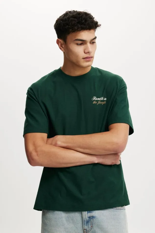 Cotton On Tees and Tanks Ali Loose Fit TShirt Lcn Ali Pineneedle Greenali 8211 Rumble In The 8211 Men Cotton On Tees and Tanks Ali Loose Fit TShirt Lcn Ali Pineneedle Greenali 8211 Rumble In The 8211 Men